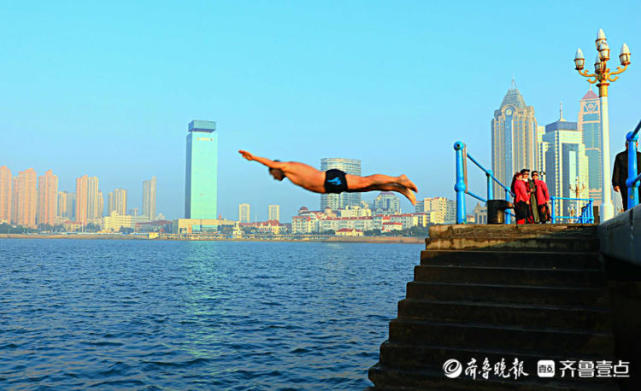情报站一跃而起如鱼入水青岛海边市民不畏严寒跳水冬泳