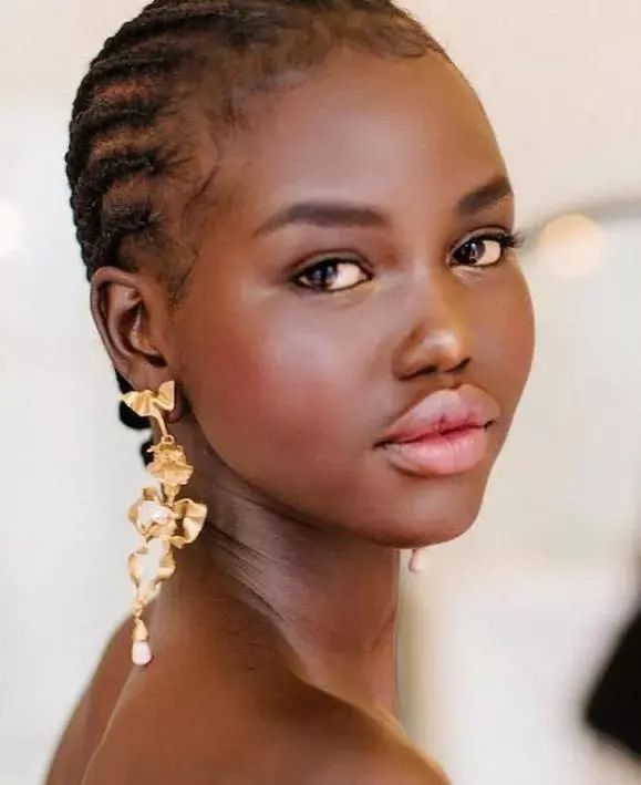 adut akech拥有典型的黑人长相,她头发卷曲,嘴唇很厚,宽宽的鼻头颇有