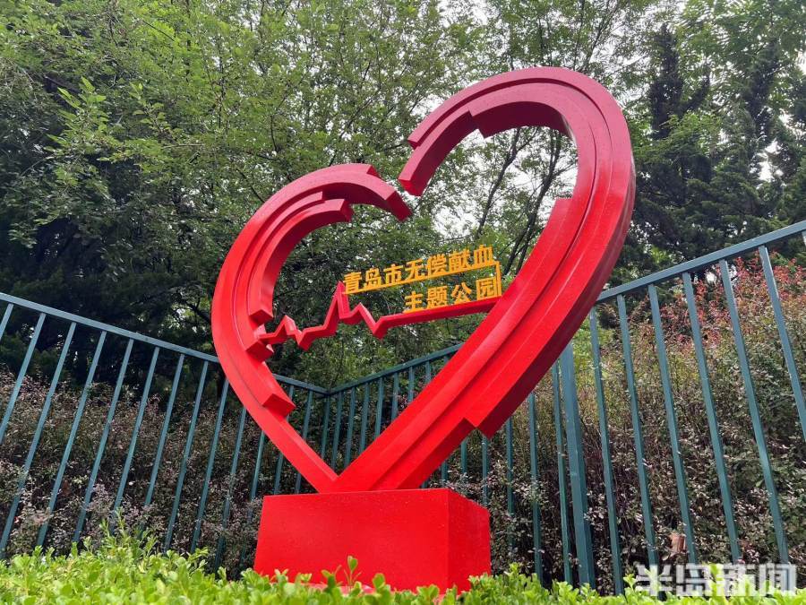 雕塑引人驻足;绿油油的枝头上,红色的福袋随风摆动……6月14日,青岛市