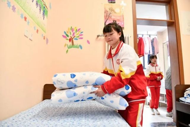 2月27日,在贵阳南明区李端棻中学,潘雪菲在宿舍里整理床铺.