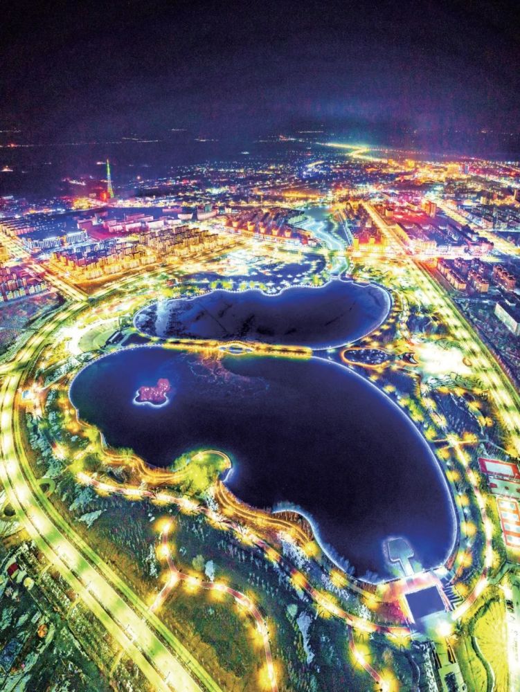 图为鸟瞰巩留县蝶湖夜景.