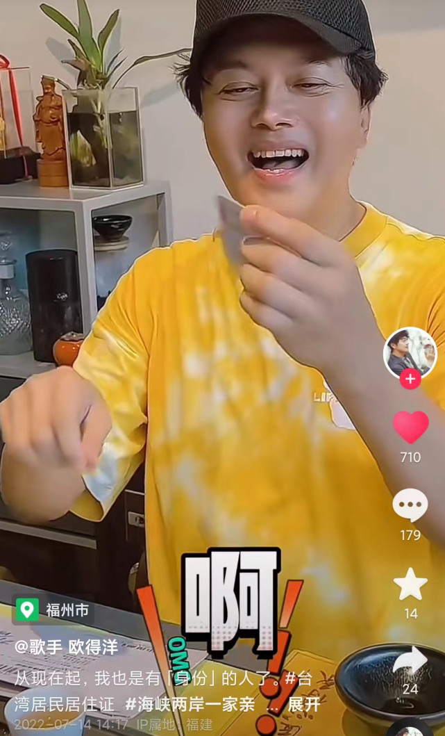 欧得洋坐在办公室里喝茶,他上身穿了黄色t恤,头戴棒球帽,打扮年轻有