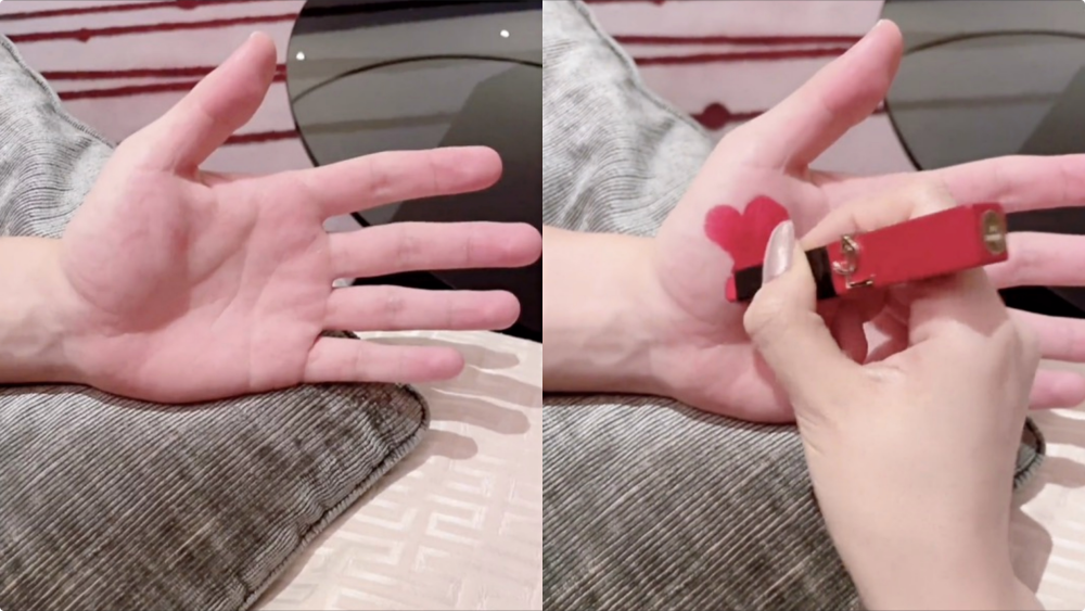 何捷一只手出镜,张馨予用口红在老公的手掌上画了一颗爱心.