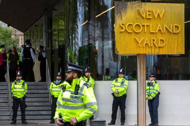 10月14日,英国伦敦,警察在伦敦警务处总部外的标志牌旁守卫.