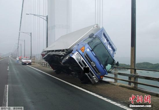 图为日本坂出，一辆卡车被大风吹翻。