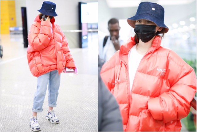 杨超越现身机场,牛仔裤脚卷起配休闲鞋,橙红色羽绒服十足抢镜