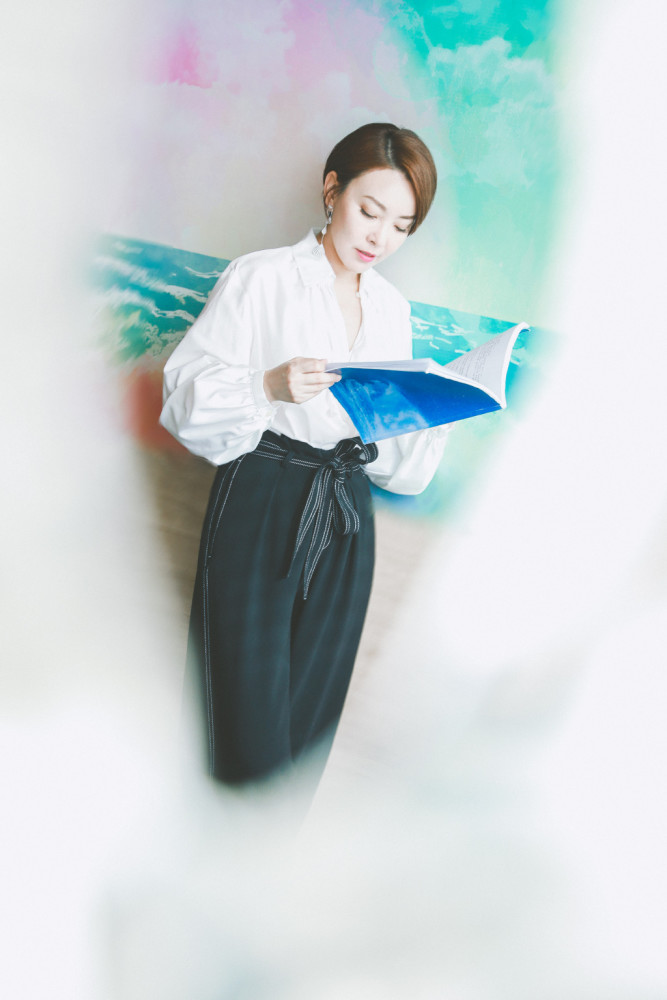 剧中饰演马丽的小姨,穿白衬衣配高腰休闲裤,戴