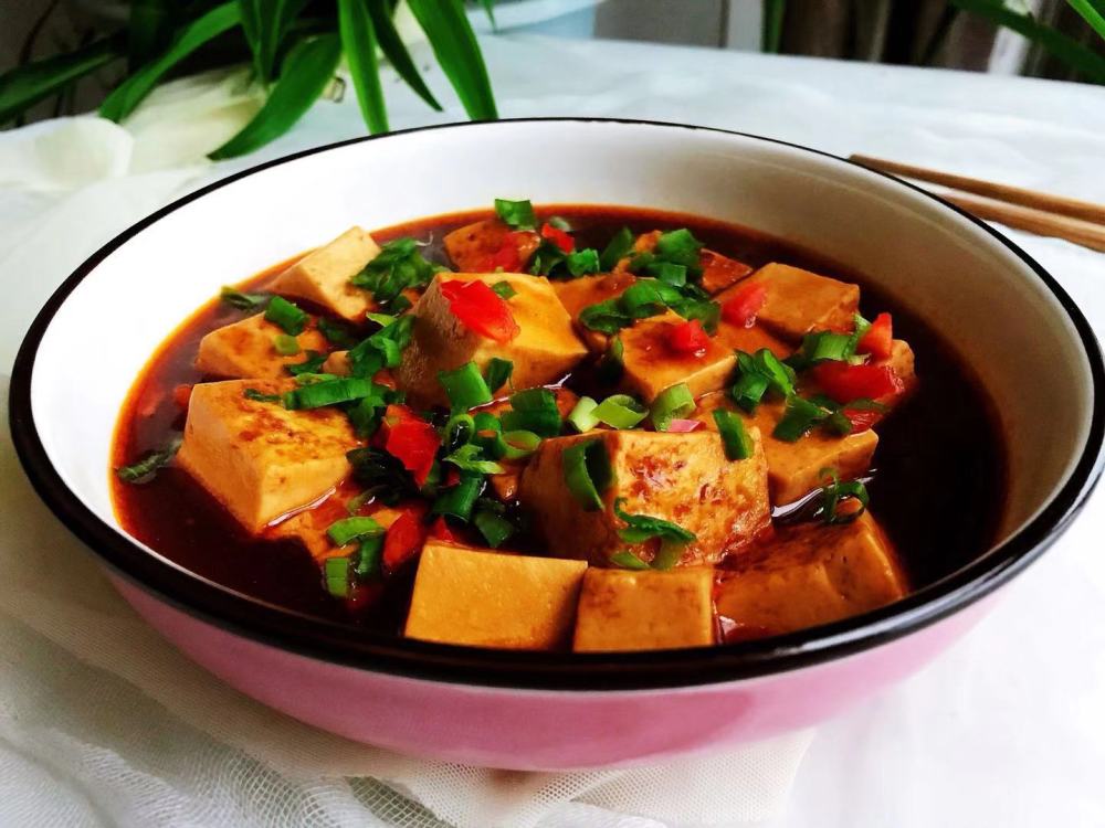 步骤五:装在盘子中的红烧豆腐块,上面撒葱花以及甜椒丁,好吃又好看.