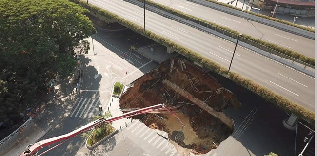 6日凌晨,搜寻人员在广州市广州大道北与禺东西路交界的地面塌陷地点的