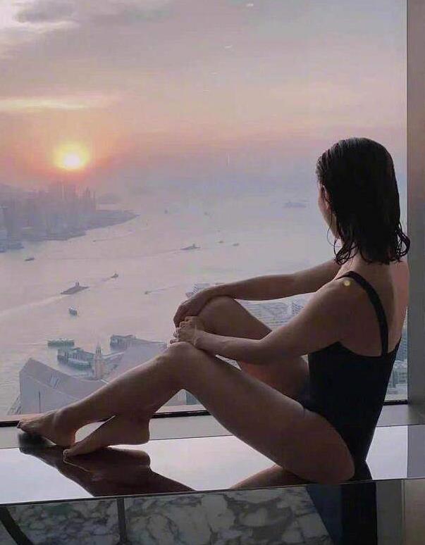 49岁黎姿真放得开!穿黑色连体泳衣太性感,坐在阳台欣赏夕阳美景