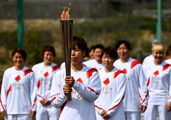 日本前女足队员岩清水梓（前）在火炬传递中。