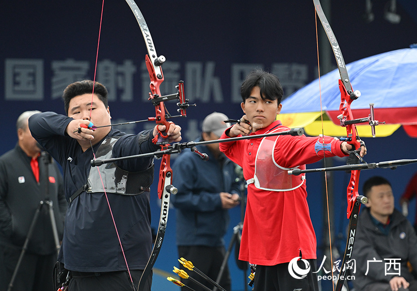 比赛现场.人民网 雷琦竣摄教练在鼓舞射箭运动员.