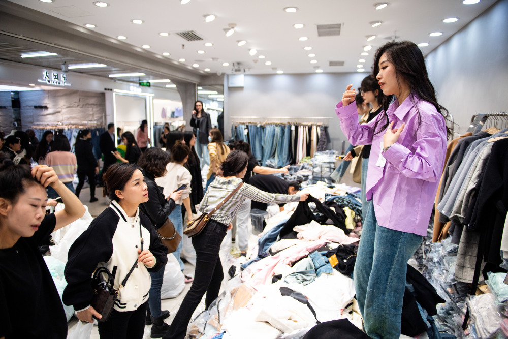 2月28日,模特(右一)在湖南省株洲市芦淞区华丽服装批发大市场向批发商