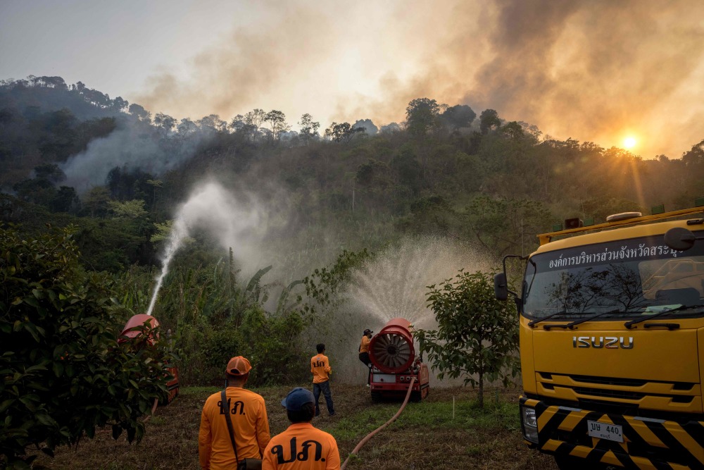 新华社/法新3月31日,消防与救援人员在泰国那空那育府参与灭火行动.