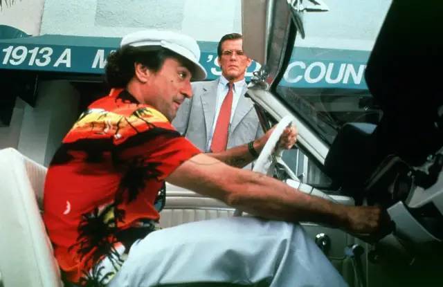 卡迪慢吞吞地走进一家电影院(正在放映喜剧片《天才小捣蛋》),站在这