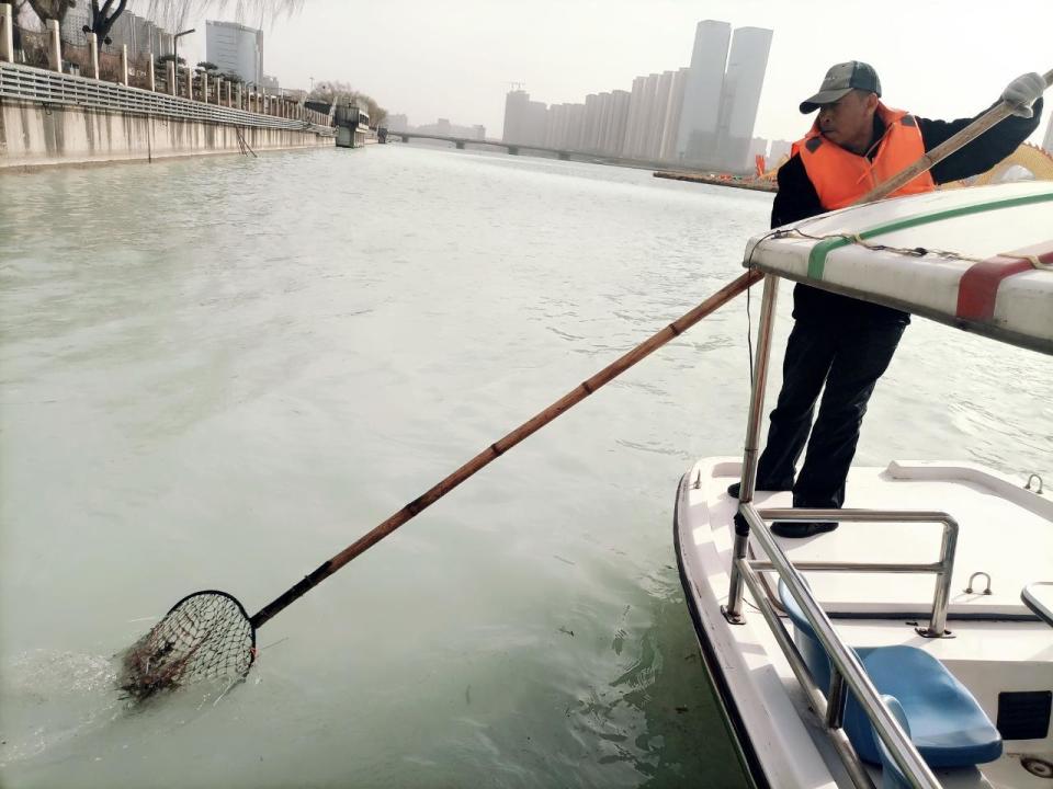 太原汾河景区有支打捞队划着小船守护碧水清波