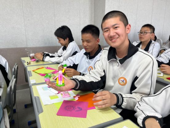 在哈密市第八中学"生命教育"的心理课堂上,教师引导学生用彩泥,卡纸