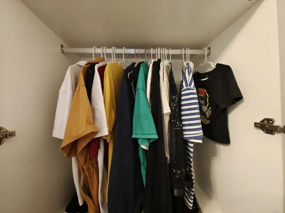 把衣服挂起来,打开衣柜门,衣柜里的衣物一目了然,无论是取用还是挂放