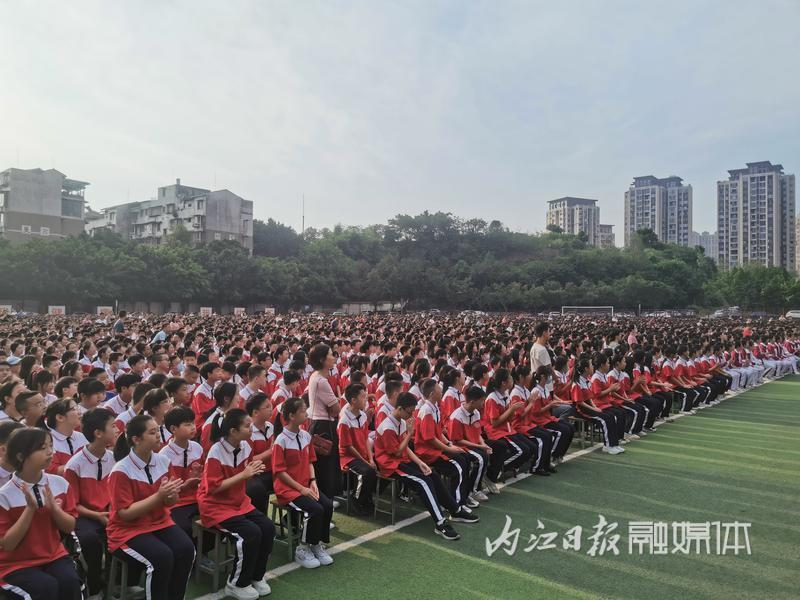 当天上午,在资中县第二中学操场上,红白相间的校服衬得端坐整齐的学生